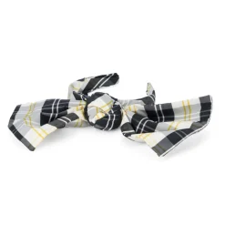 Cerchietto per capelli sui toni dei bianco panna, nero e giallo con grande fiocco decorativo.